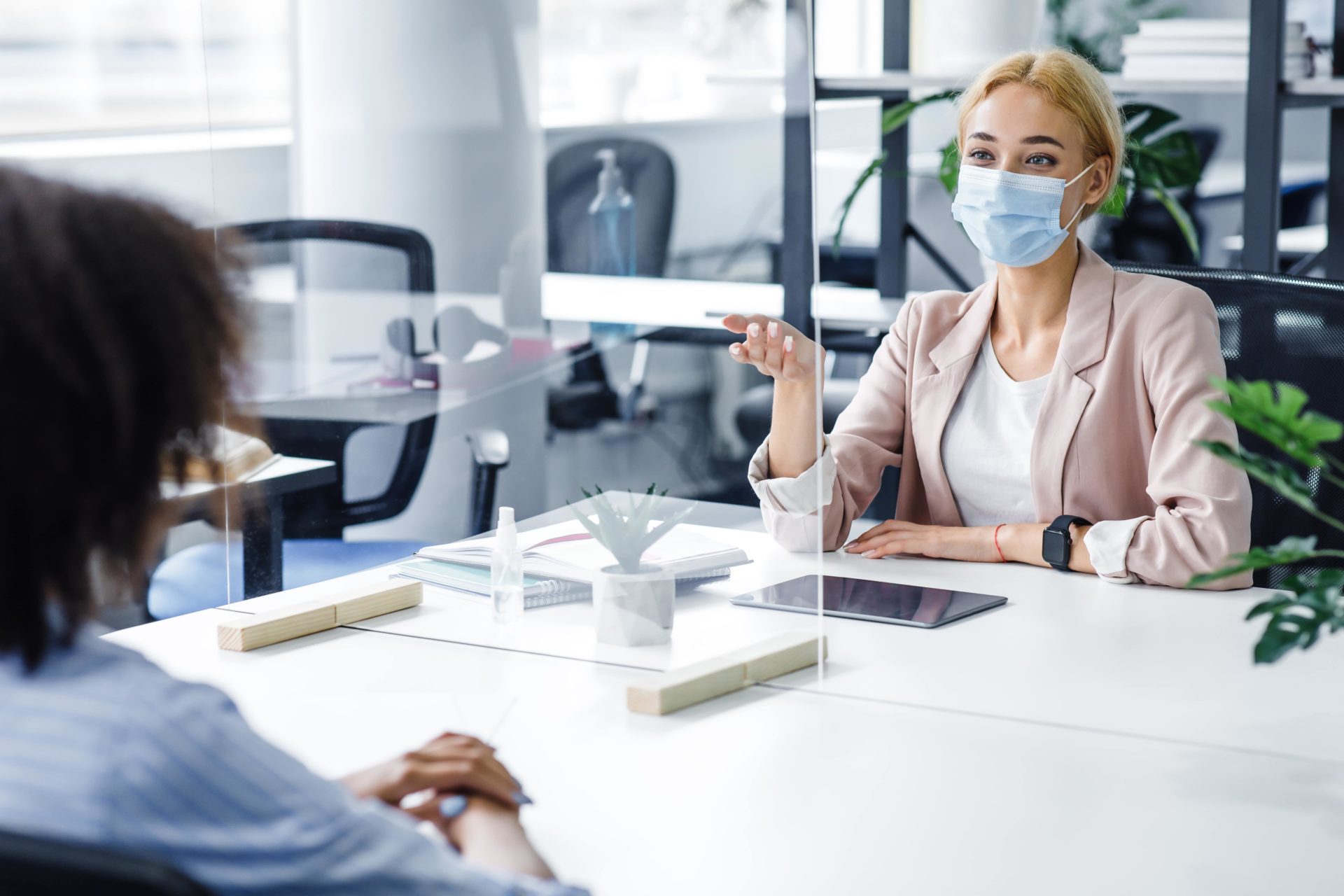 employees protected by glass screen in the office