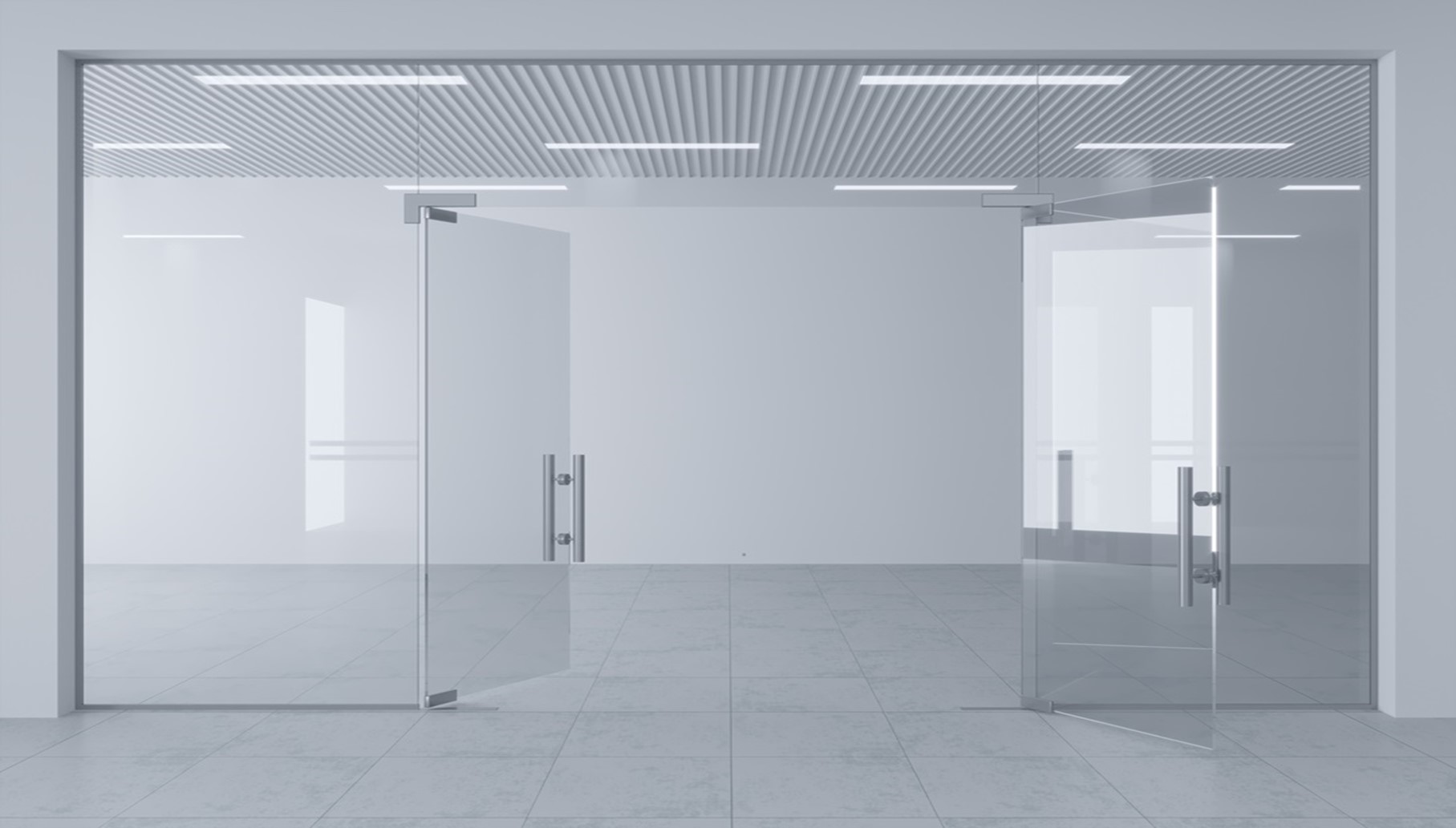 A frameless glass paritioning system in a white office
